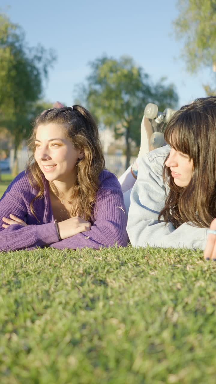 Young Women Relaxing on the Grass in a Park