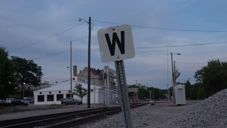 west sign on railroad tracks