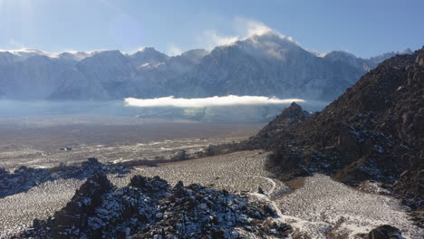 Aerial-view-over-Alabama-hills-snow-covered-and-East-Sierra-Nevada-mountain-range-in-the-background