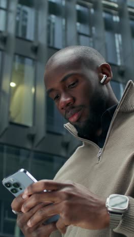 man using smartphone in city