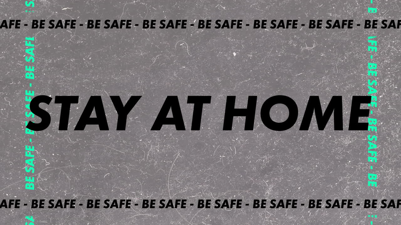 "안전해라, 집에 있어라"라는 단어가 회색 바탕에 검은색과 초록색 글자로 쓰여져 있습니다.