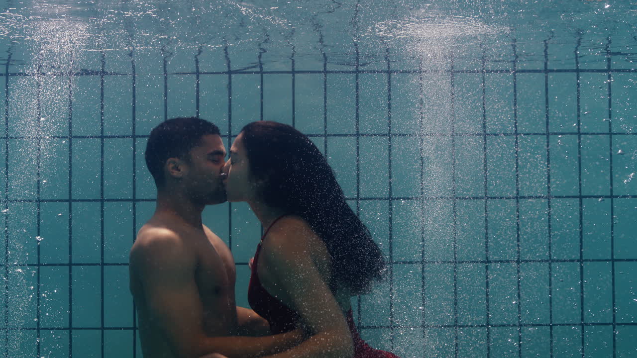 Playful Couple Kissing Underwater In Swimming Pool Young People Enjoy Romantic  Kiss Passionate Lovers Submerged In Water Floating With Bubbles Enjoying  Romance Free Stock Video Footage Download Clips