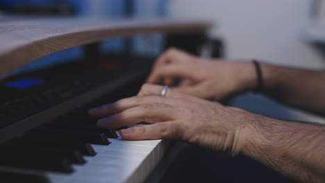 mano caucásico hombre de cerca mientras realiza una sesión de piano de estudio grabando un nuevo álbum