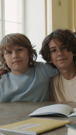 young boys studying and sharing a moment together