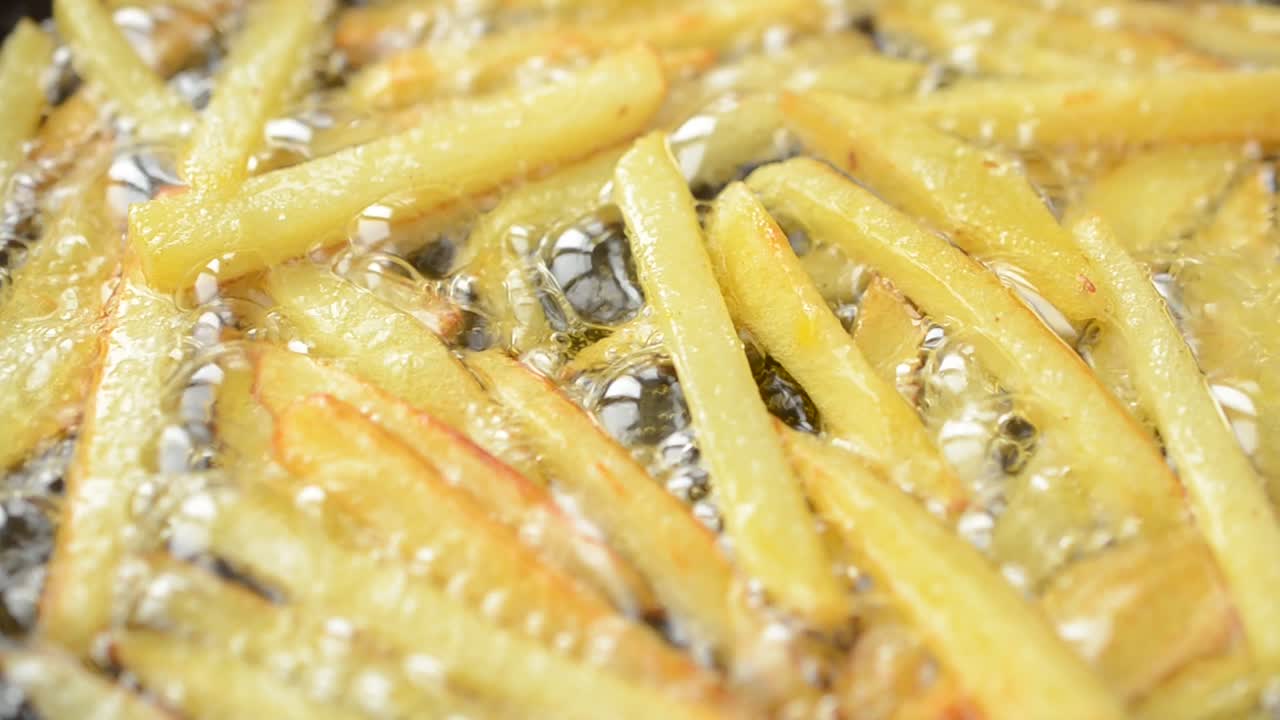 Wir frittieren Pommes frites. Pommes frites in einer Pfanne.