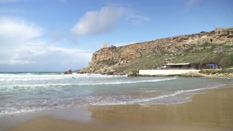 Ghajn-Tuffieha-Bay-on-a-Sunny-Day-with-Turquoise-Colour-Water-Waving-in-Shore