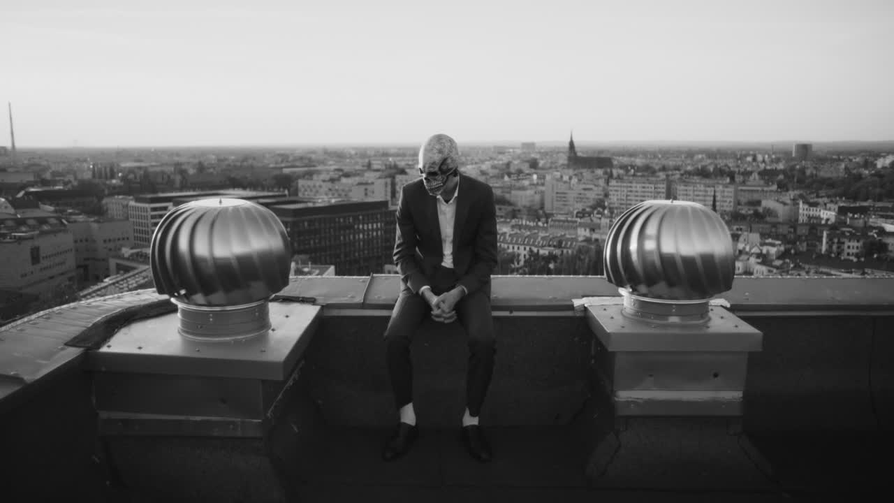 Monochrome Skull Figure on Urban Rooftop