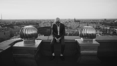 monochrome skull figure on urban rooftop