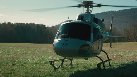 Slow-motion-dolly-shot-of-an-idling-helicopter-with-a-solar-flare