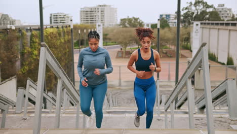 two women running up stairs and celebrating