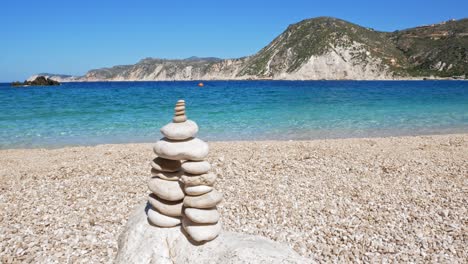 rock balancing, stone stacks on the beach of agia eleni in greece - static shot