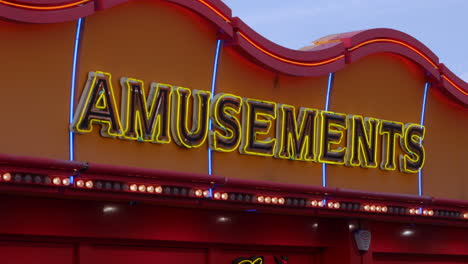 amusement arcade sign above a casino on a cloudy day