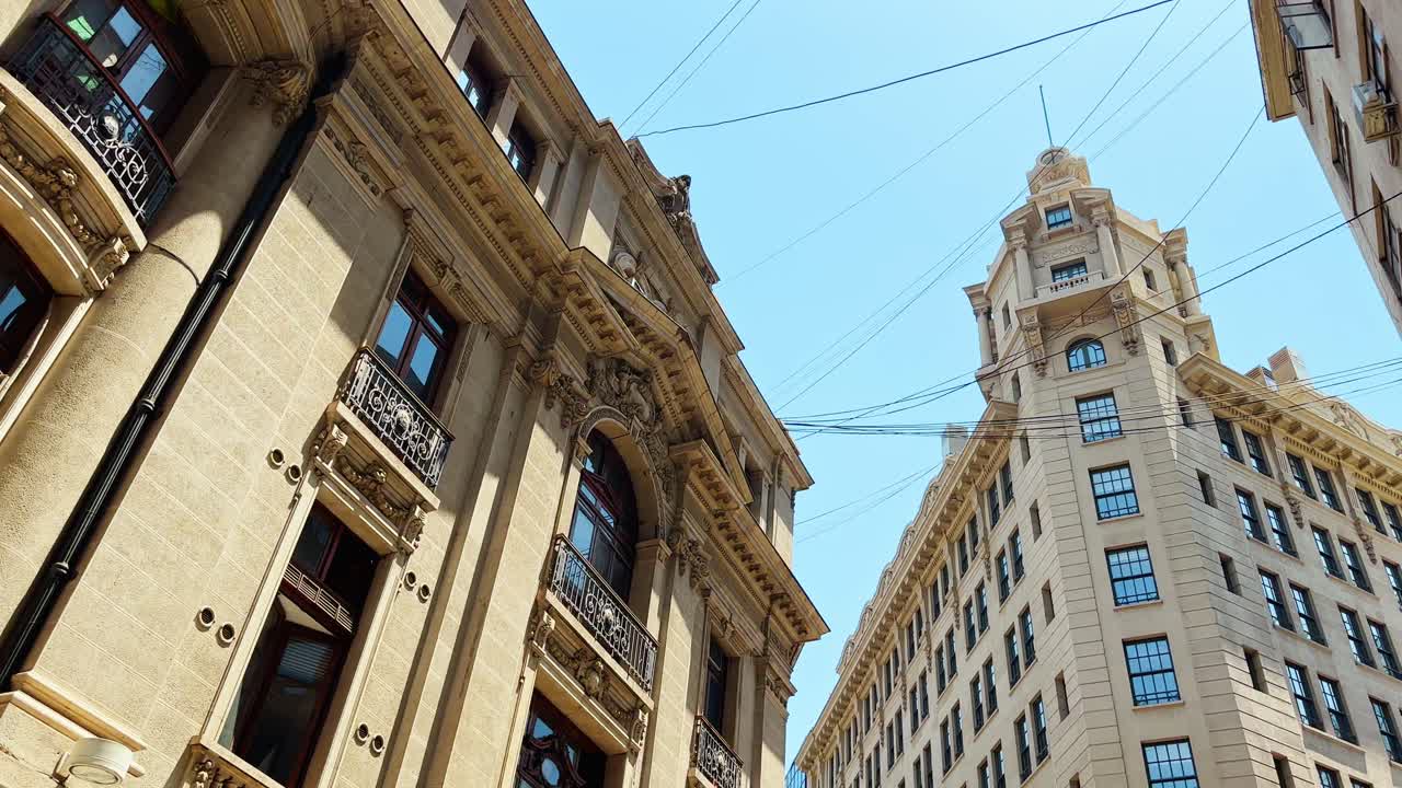 Truck right establishing of the New York architecture of downtown Santiago, Arizt&iacute;a Building and the stock exchange, Chile - Hanging cables
