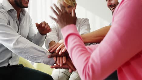 businesspeople forming hands stack