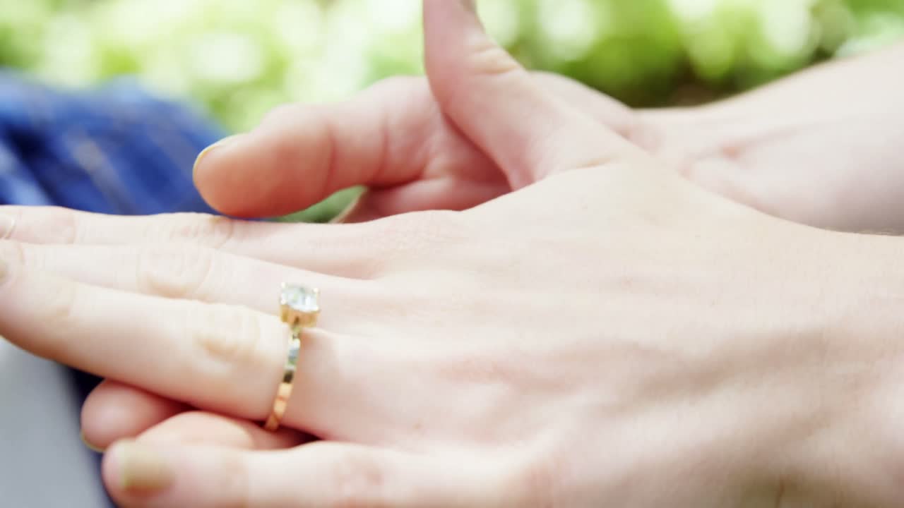 Woman hand wearing engagement ring