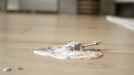 melted ice cream on wooden floor