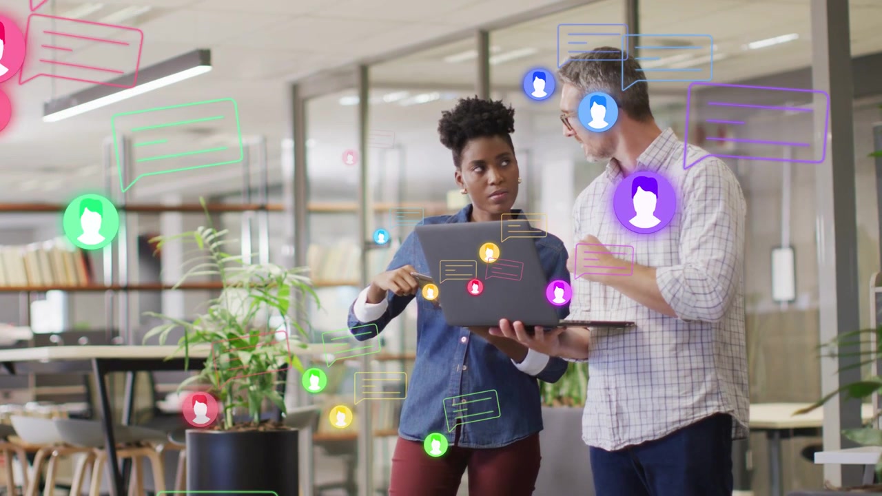 Woman tapping laptop screen and man pointing, creating floating UI bubbles for business review