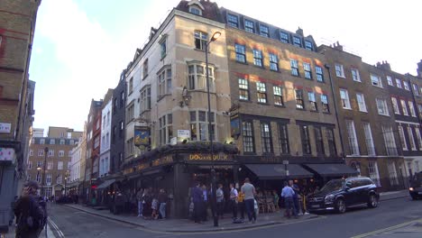 locals have a drink at a corner pub after work in downtown london england