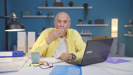 home office worker old man looking at camera confused.