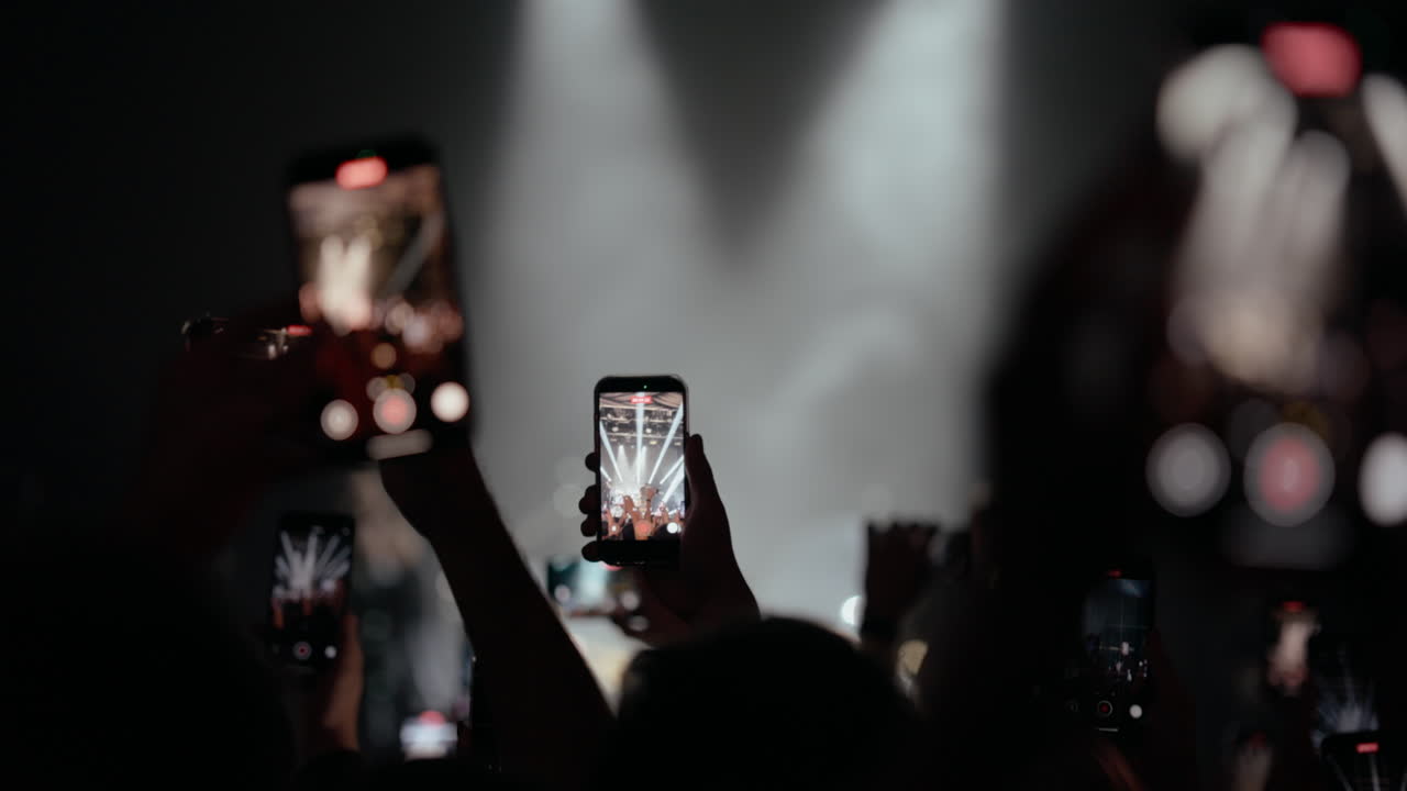 Crowd of People Recording a Live Concert with Smartphones