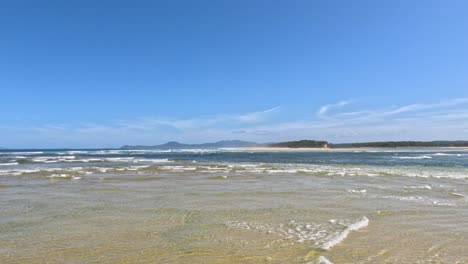 gentle waves wash over sandy beach