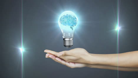 holding glowing light bulb with brain animation over dark background