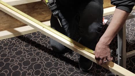 man drilling wood with a power drill