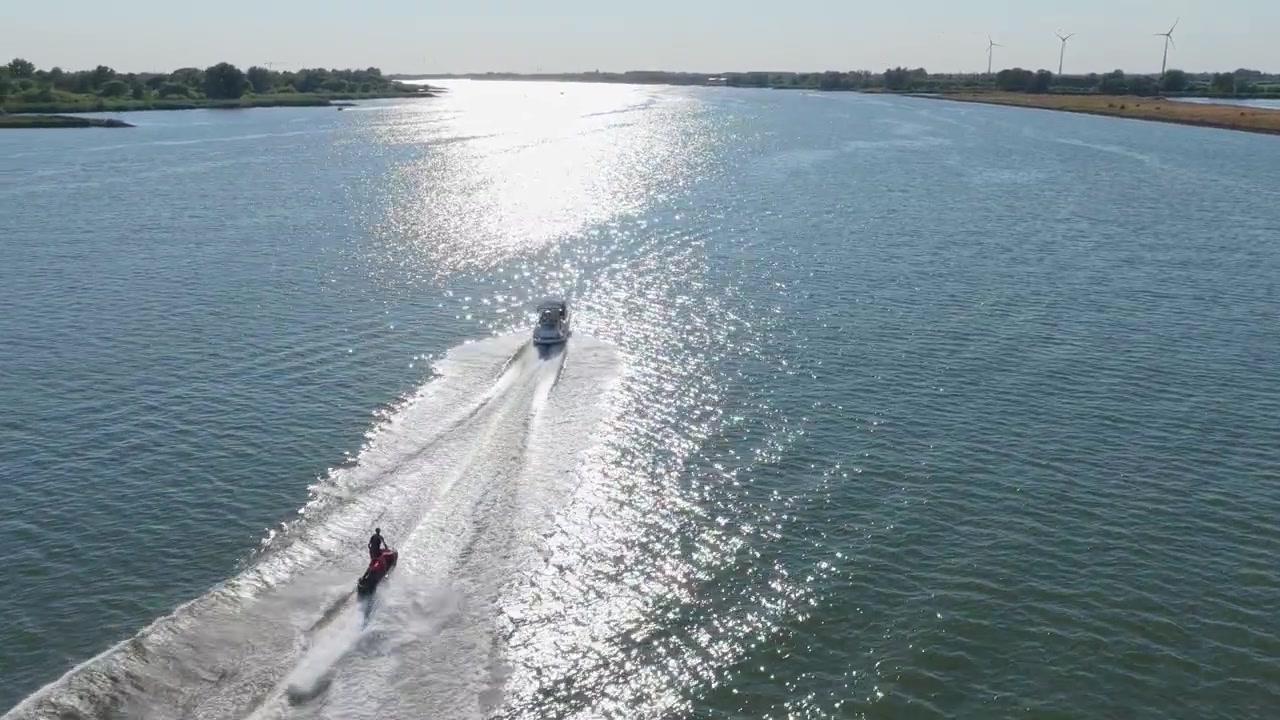 Aerial View of a Person Riding a Jet Ski on a River