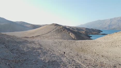 Solitaire-woman-hike-moonlike-path