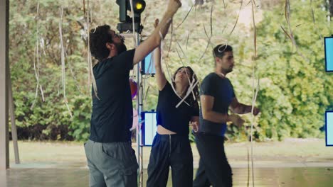 people decorating an outdoor event space with balloons and lights