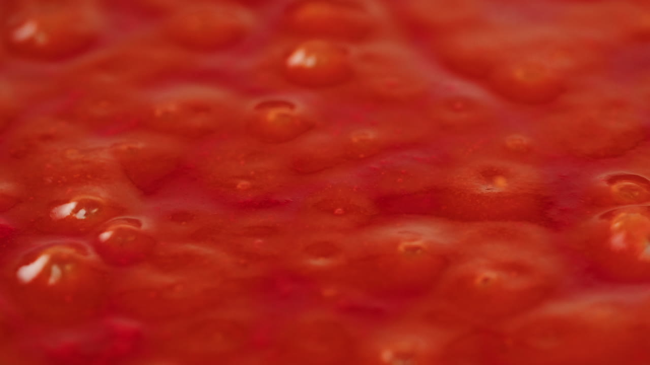 Chicken in tomato sauce is boiling on a frying pan with spices. Cooking tomato sauce curry with chicken fillet. Traditional Italian Mexican Asian dish. High quality studio shot for cafe, restaurant close up.