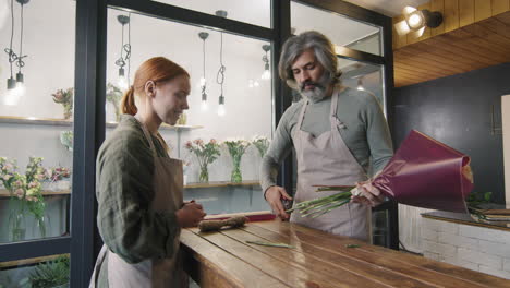 florists cutting flower stems in bouquet
