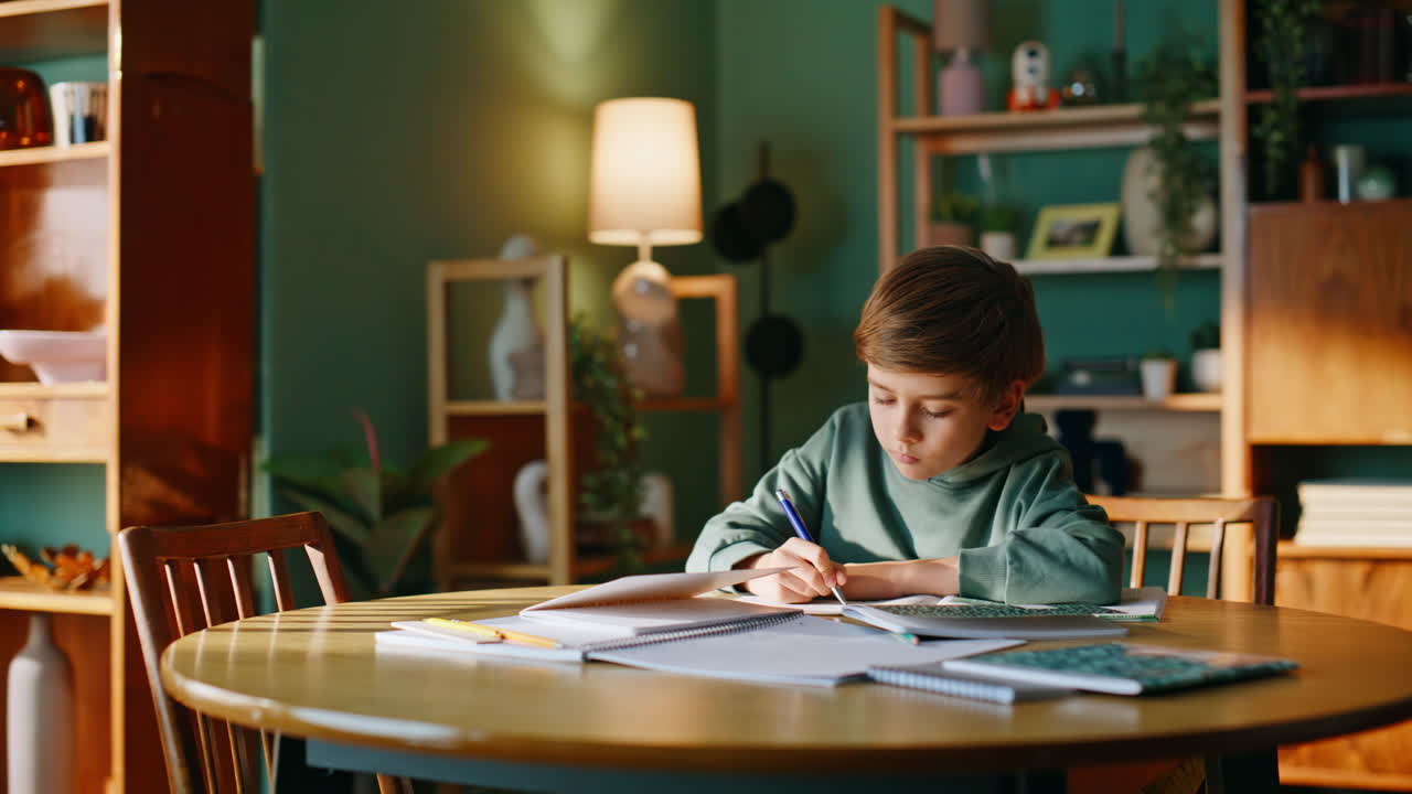 Serious pupil thinking task doing homework home. Elementary school student