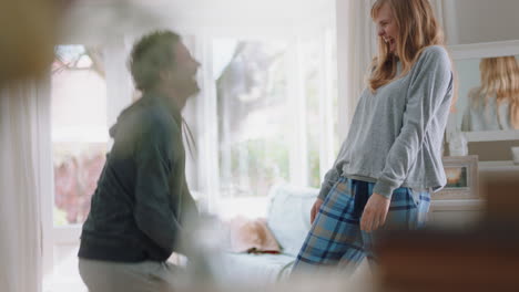 happy young couple dancing at home celebrating having fun weekend morning together enjoying funny dance in bedroom successful relationship celebration 4k footage