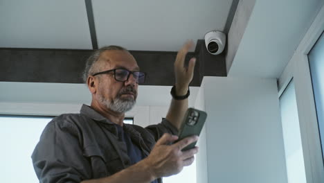 man installing security camera