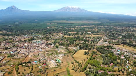 Aerial-drone-view-Open-Air-market-in-the-Loitokitok-town,-Kenya-and-mount-Kilimanjaro--Rural-village-of-Kenya