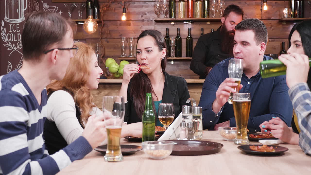 People enjoying food and drinks at a restaurant