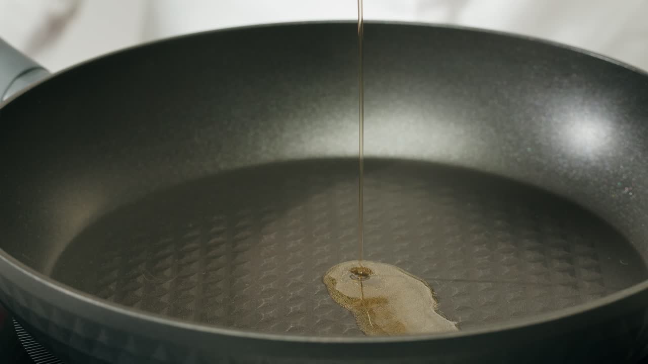 Pouring oil into a pan