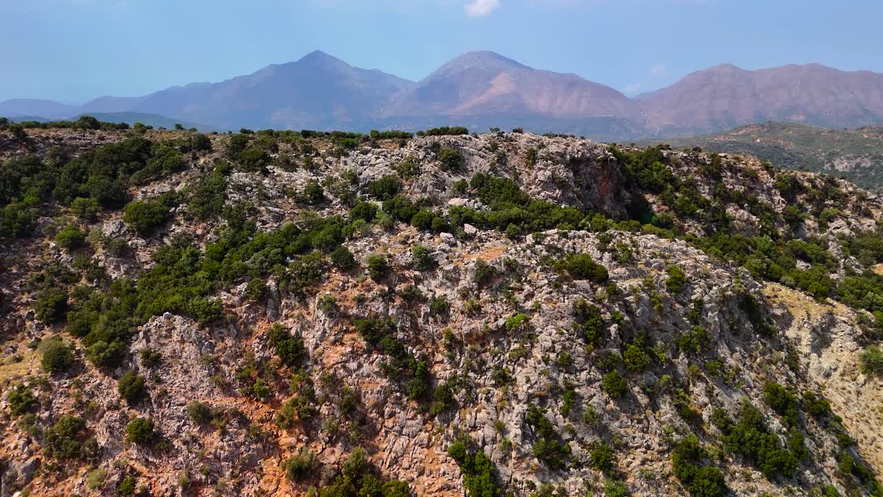 Visitors enjoy breathtaking views of rocky hills and lush greenery in Crete, showcasing the beautiful natural scenery under a bright blue sky