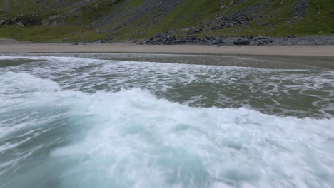 waves crushing in on the shore at a secluded beach in lofoten, norway