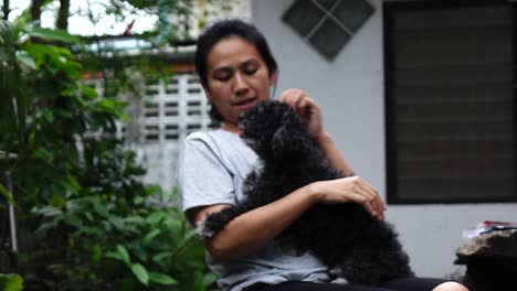 woman is resting with a dog at home