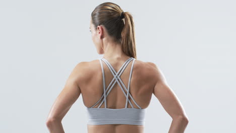 young caucasian woman athlete in fitness attire on a white background