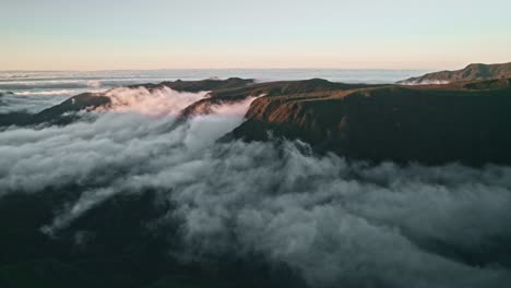 madeira, mountain landscape at sunset over clouds, fog, valley, dramatic, aerial, droneshot