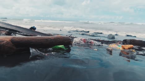 polluted ocean shore with lot of plastic garbage thrown ashore by sea waves