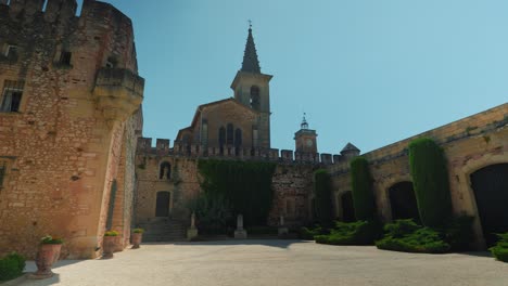 slow establishing shot of chateau de pouzilhac with a open courtyard