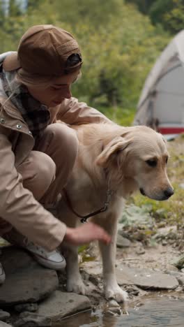 woman and dog by a creek