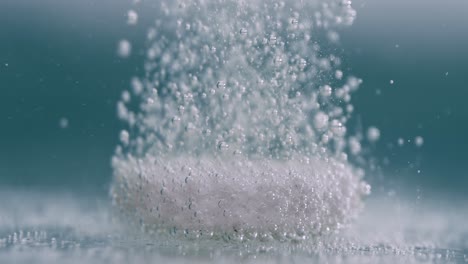 Extreme Close-up effervescent tablet, pill bubbling underwater. Shot on super slow motion camera 1000 fps.
