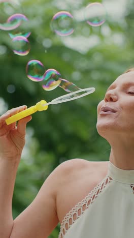 woman blowing bubbles in a park