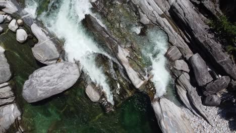 aerial top down shot of floating ticino river between rocks in switzerland,europe at sunny day