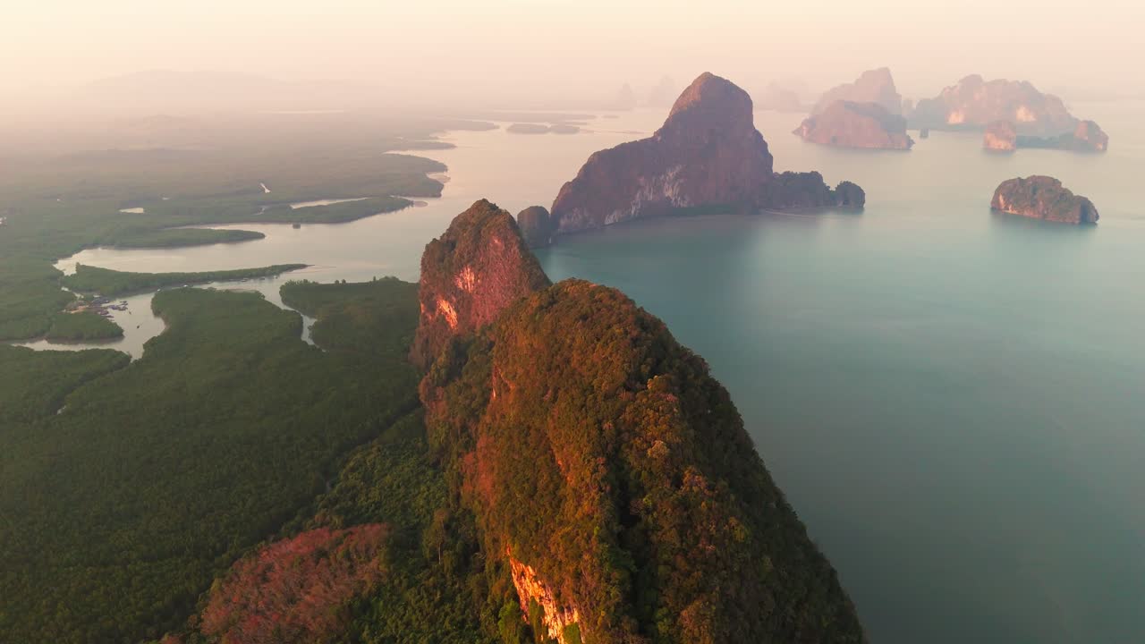 Aerial Thailand Andaman Sea between the island of Phuket Krabi in Ao Phang Nga National Park during sunset, limestone mountains and jungle forest